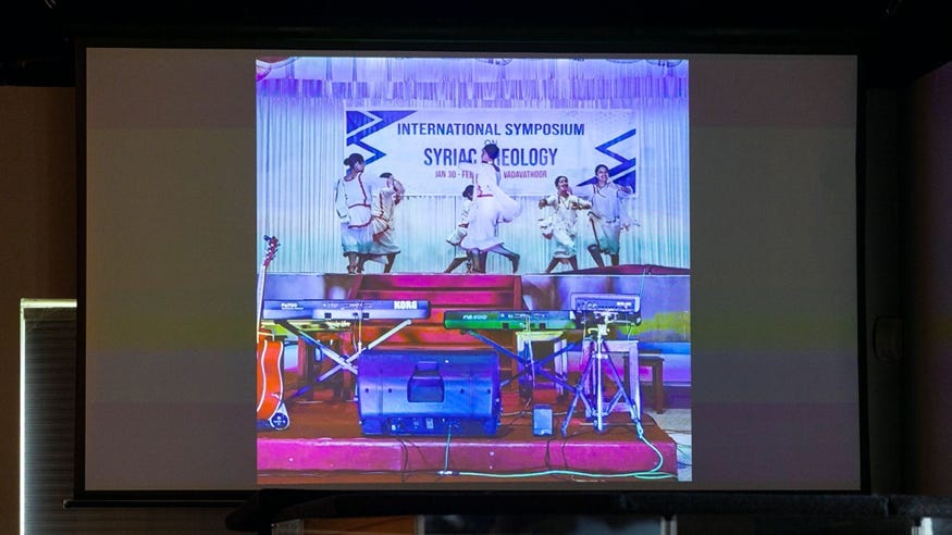 Video presentation of traditional dance performance on screen