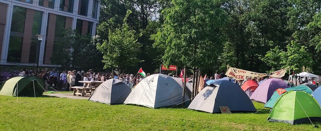 https://upload.wikimedia.org/wikipedia/commons/thumb/1/1a/Encampment_at_Radboud_University.jpg/1280px-Encampment_at_Radboud_University.jpg https://upload.wikimedia.org/wikipedia/commons/thumb/1/1a/Encampment_at_Radboud_University.jpg/1280px-Encampment_at_Radboud_University.jpg