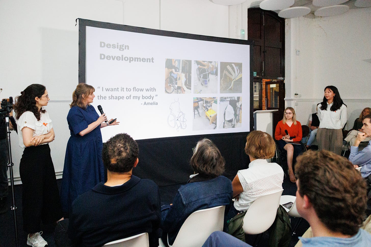 A photograph of the OSL event and presentation. Four women present in front of a projector screen.