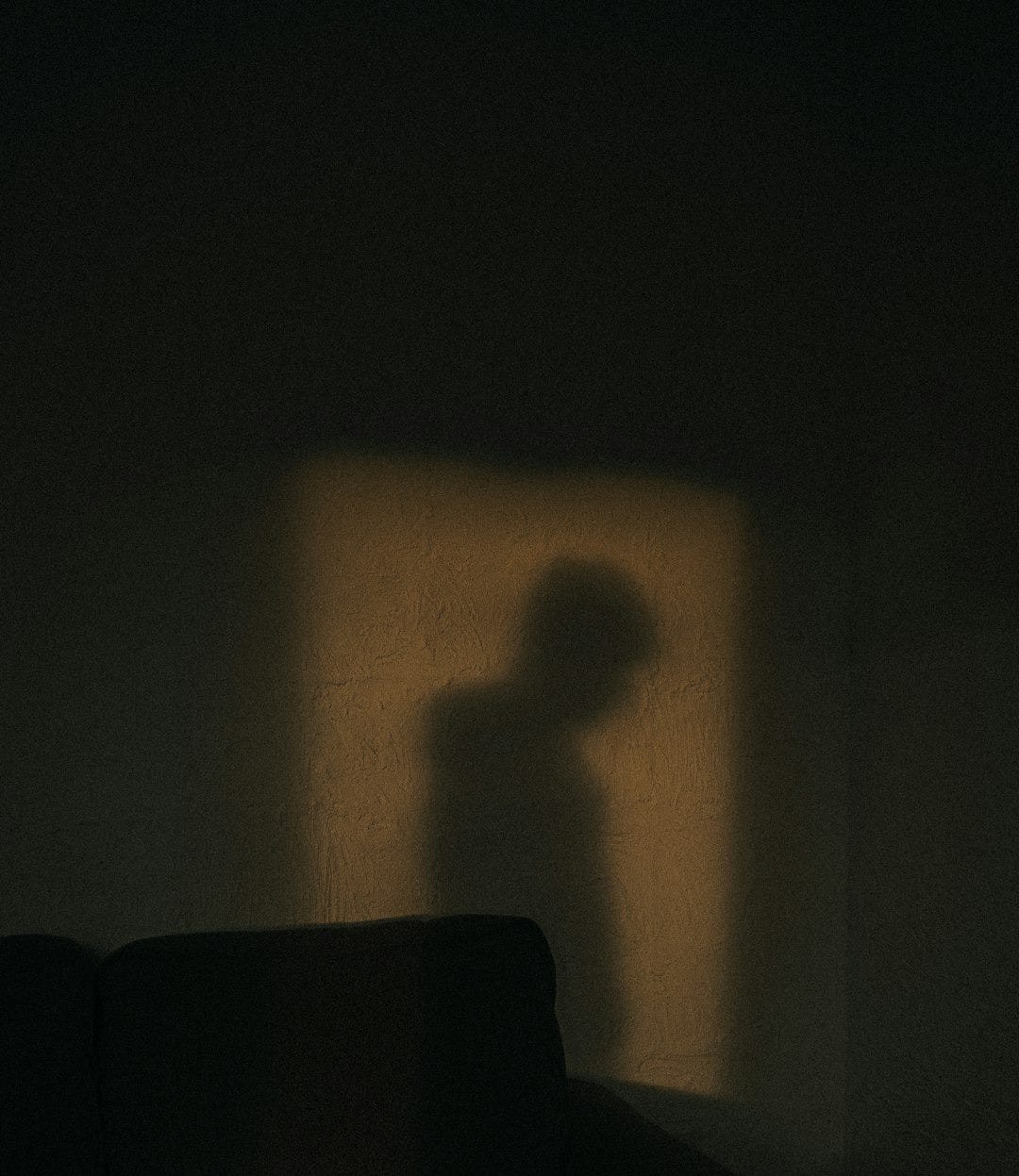 black sofa chair near white wall