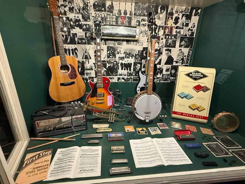 A table with musical instruments and music notes

AI-generated content may be incorrect.