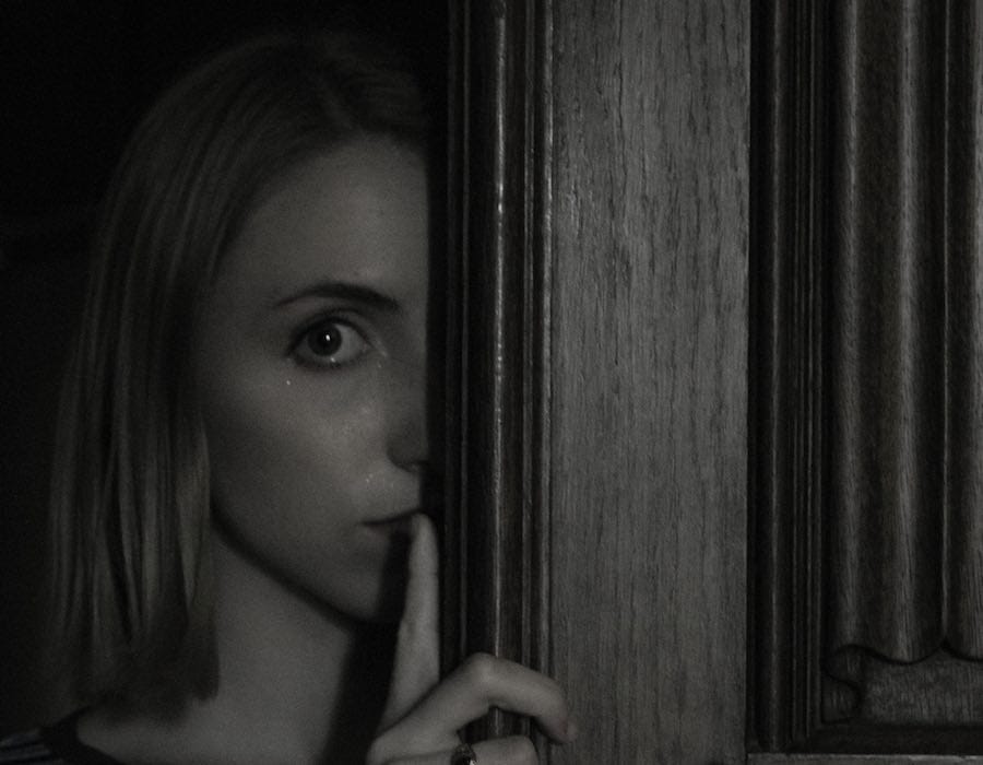 Woman listening behind a door Woman listening behind a door
