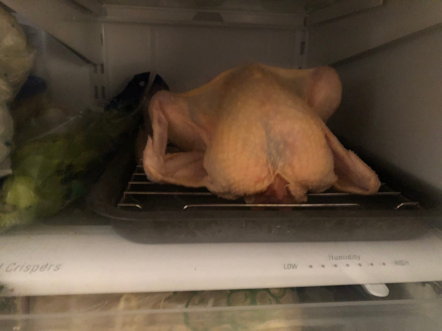 Chicken on rack on tray in fridge Chicken on rack on tray in fridge