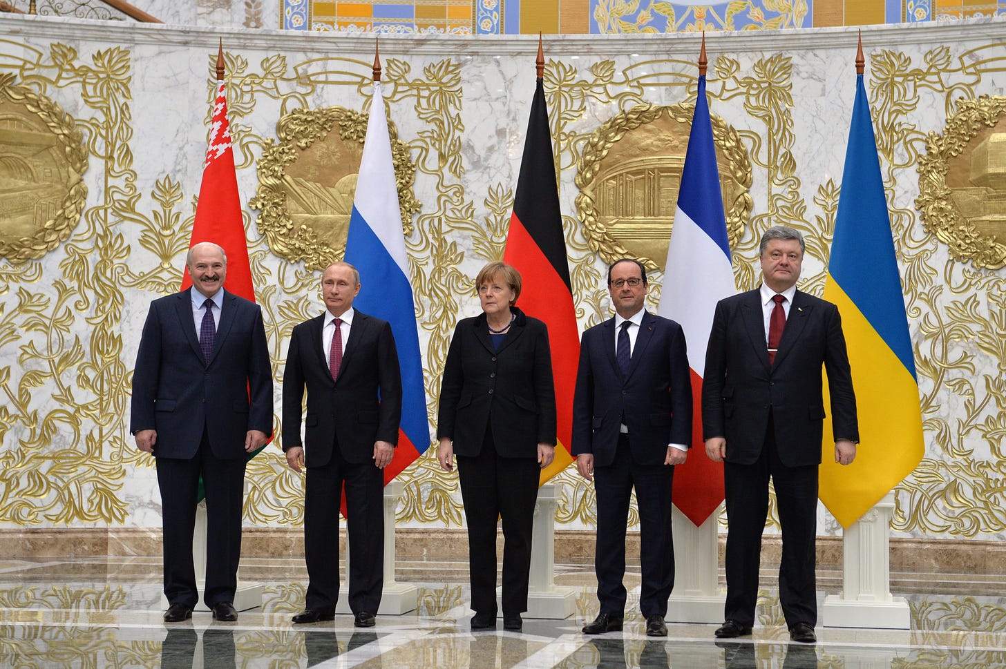 Photo from Wikimedia of Normandy formal talks in Minsk (February 2015): Alexander Lukashenko, Vladimir Putin, Angela Merkel, Francois Hollande, and Petro Poroshenko take part in the talks on a settlement to the situation in Ukraine. The Russian Presidential Press and Information Office / kermlin.ru  https://commons.wikimedia.org/wiki/File:Normandy_format_talks_in_Minsk_(February_2015)_03.jpeg