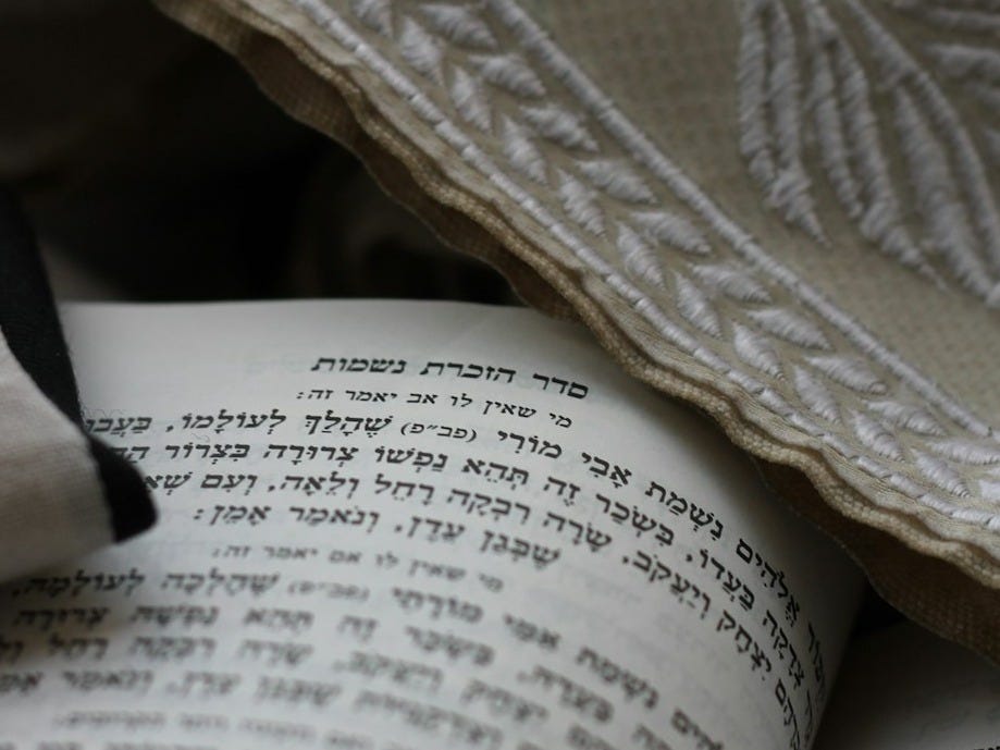 a close up of an open book on a bed a close up of an open book on a bed