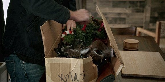 Walker digging out gun from box of christmas lights. Walker digging out gun from box of christmas lights.