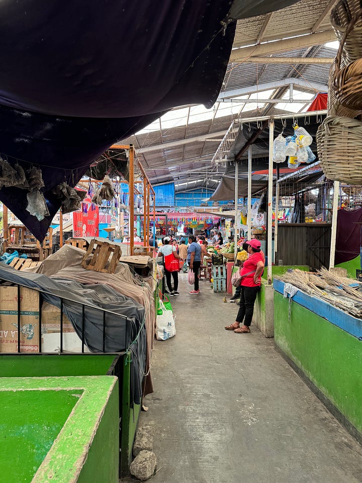 Two photographs showing the interior of the market at Etla.