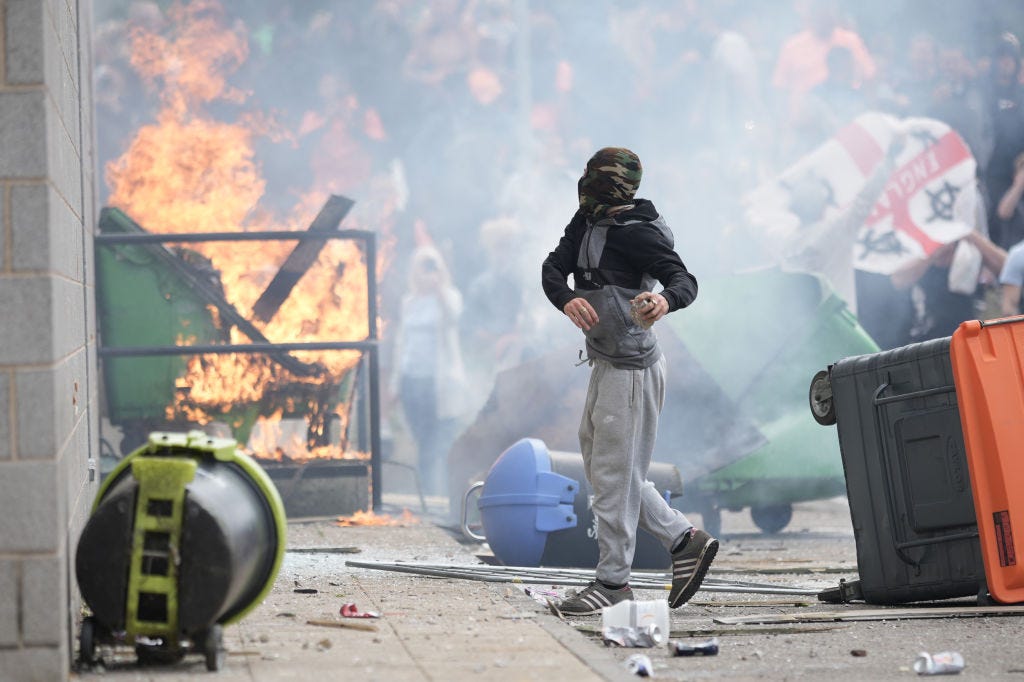 Anti-migration protesters are seen during riots outside of the Holiday Inn Express in Manvers, which is being used as an asylum hotel, on August 4, 2024 in Rotherham, United Kingdom. Yesterday saw widespread violence as Far-right agitators in Liverpool and Manchester rioted and looted shops. Police were attacked and injured and dozens of arrests were made.