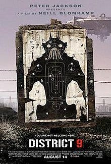 On dirty dusty ground, a black and white target practice poster of a bipedal insect-like creature stands, riddled with bullet holes. Barbed wire runs behind the poster and a large circular spaceship hovers in the background. On dirty dusty ground, a black and white target practice poster of a bipedal insect-like creature stands, riddled with bullet holes. Barbed wire runs behind the poster and a large circular spaceship hovers in the background.
