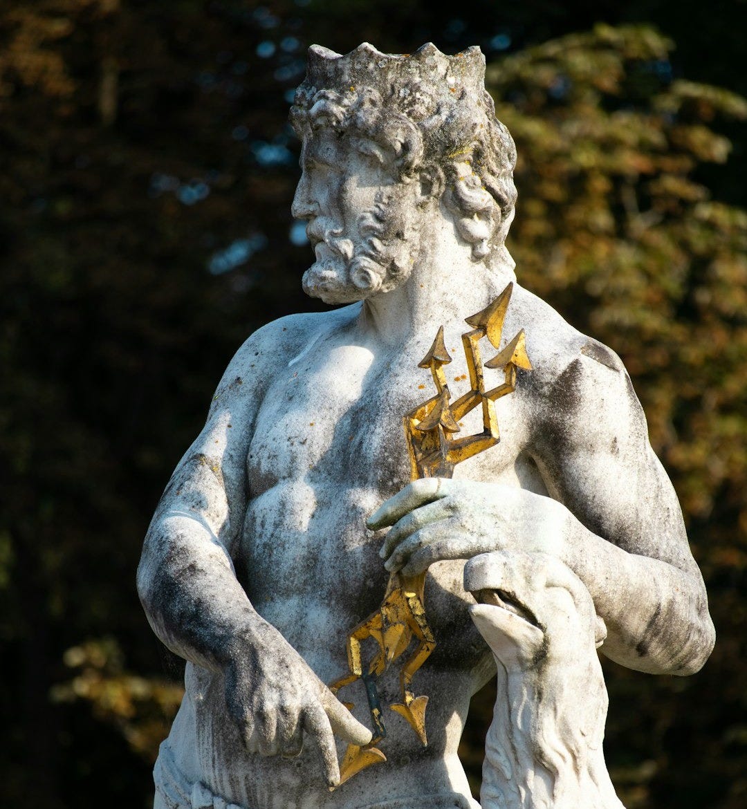 Marble statue of neptune holding a trident and a ram Marble statue of neptune holding a trident and a ram