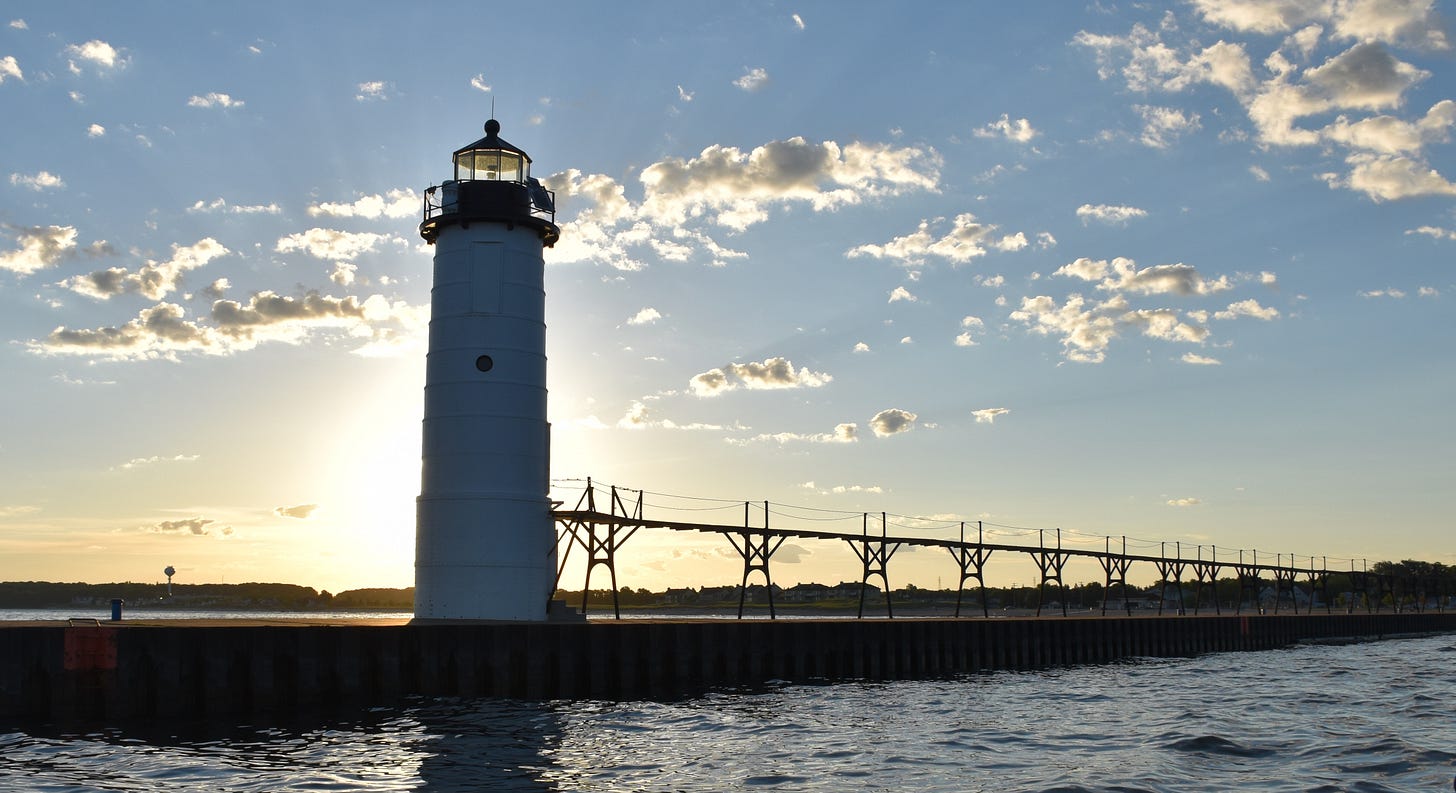 A channel marker in Lake Michigan at sunrise.