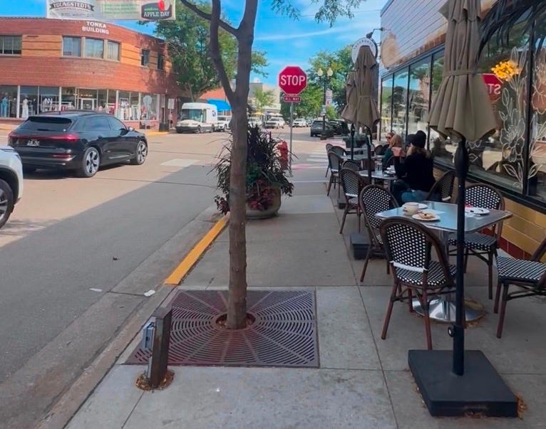 A sidewalk with tables and chairs on it
Description automatically generated A sidewalk with tables and chairs on it
Description automatically generated