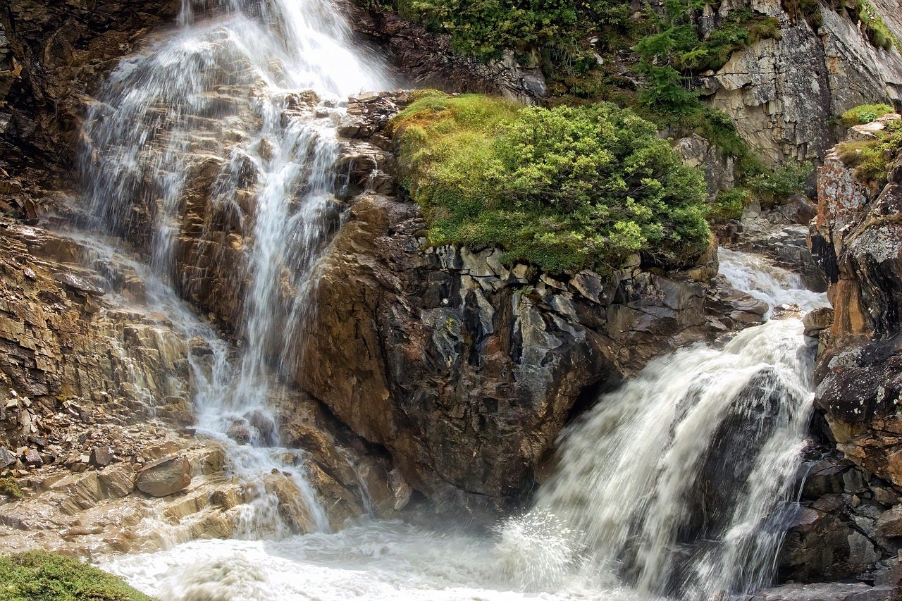 a waterfall pouring over rocks