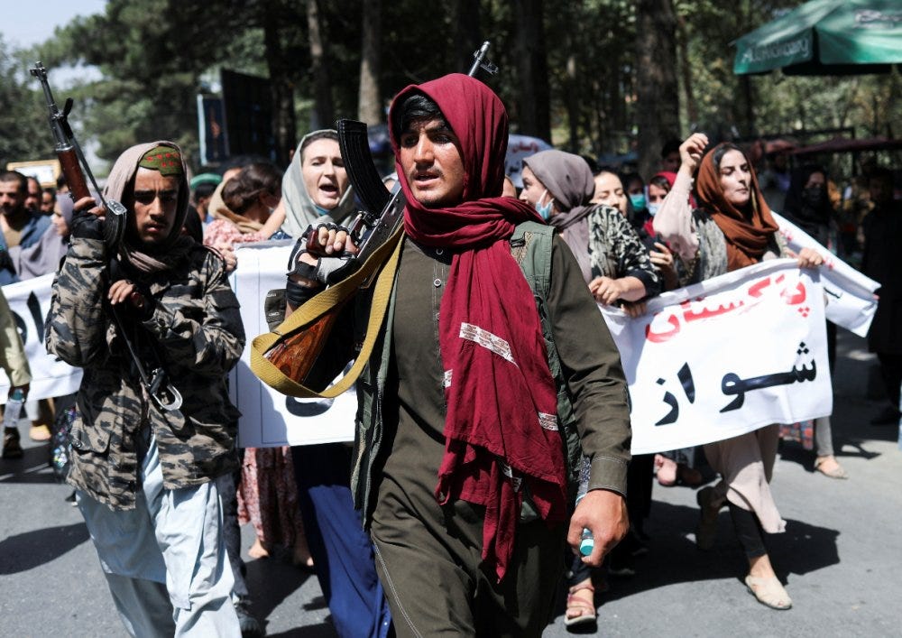 A group of people holding signs

Description automatically generated with medium confidence