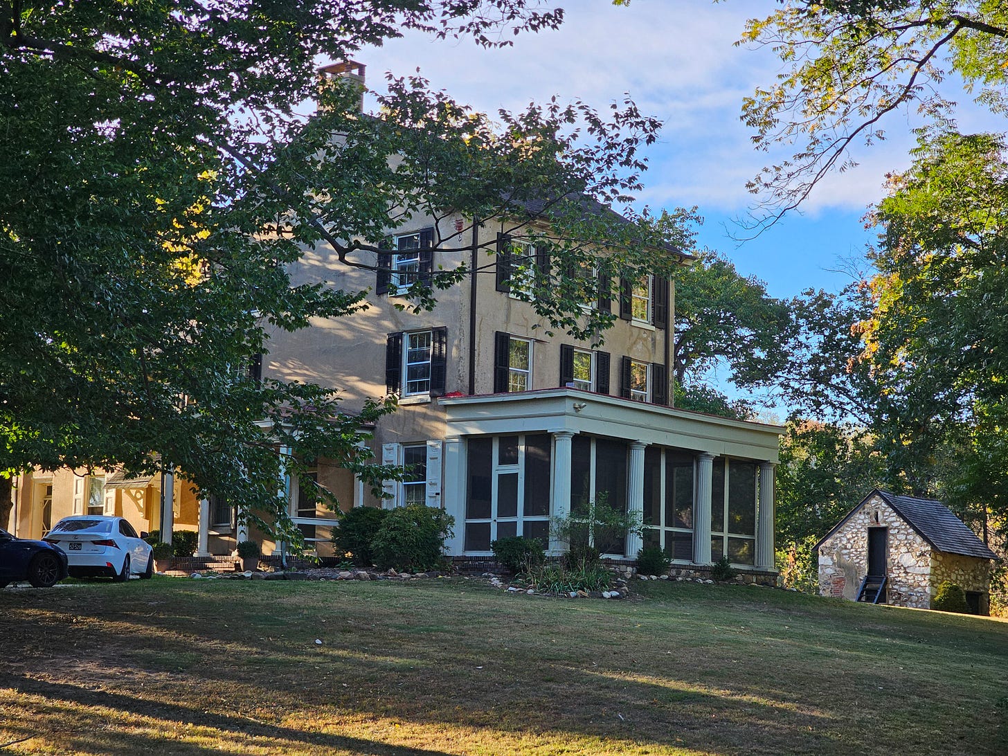 A large farmhouse with green shutters stands on the Cooch's Bridge Battlefield in Delaware.