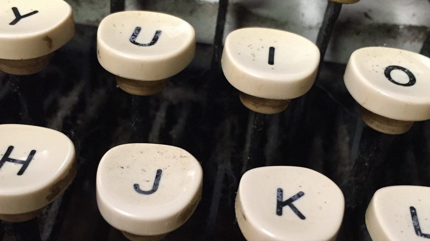 a closeup of typewriter keys on the middle top and home row of a manual typewriter