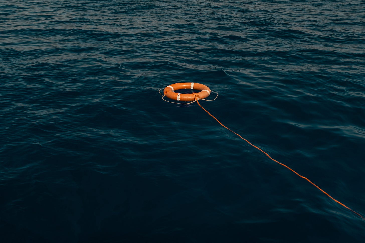 Orange life buoy floating in water