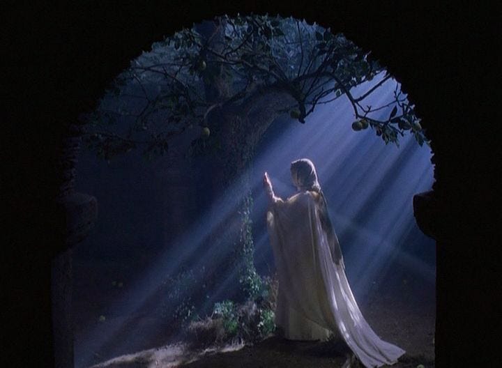 This may contain: a woman dressed in white is holding her hand up to the light coming from behind