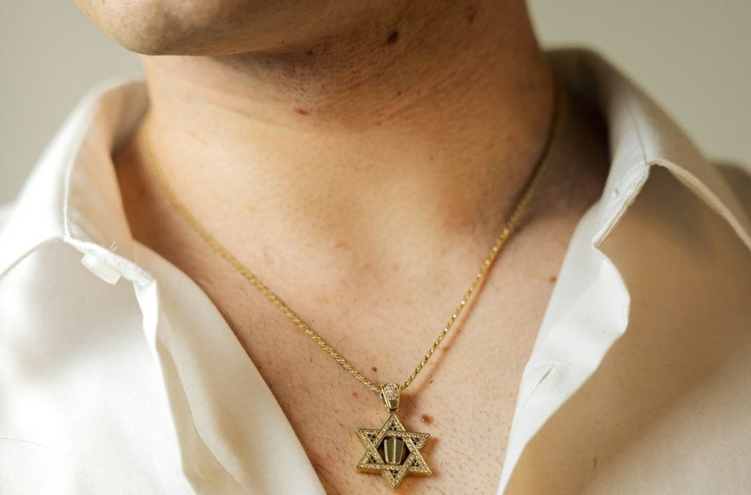 Man wearing a star of david necklace