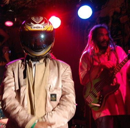 HR from the Bad Brains wearing a full face motorcyle helmet on stage