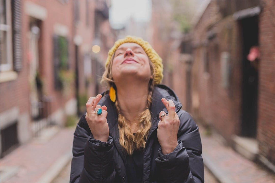 woman in black jacket wearing yellow knit cap woman in black jacket wearing yellow knit cap