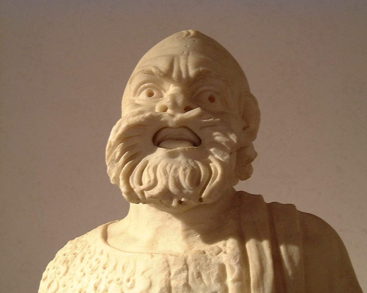 a marble statue of an actor, wearing a mask a marble statue of an actor, wearing a mask