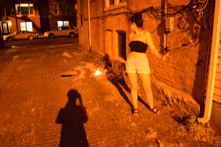 four photos of a young woman standing or crouching before burning poplar fluff in an alley