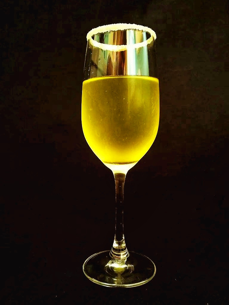 A glowing glass of grapefruit infused vodka. 