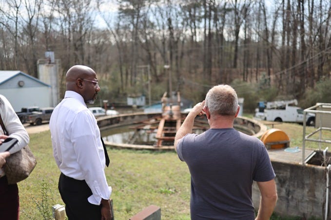 U.S. Sen. Raphael Warnock, a Georgia Democrat, visits a wastewater treatment facility in the city of Social Circle that the city says would be overwhelmed by plans to convert a warehouse to house up to 10,000 immigration prisoners.