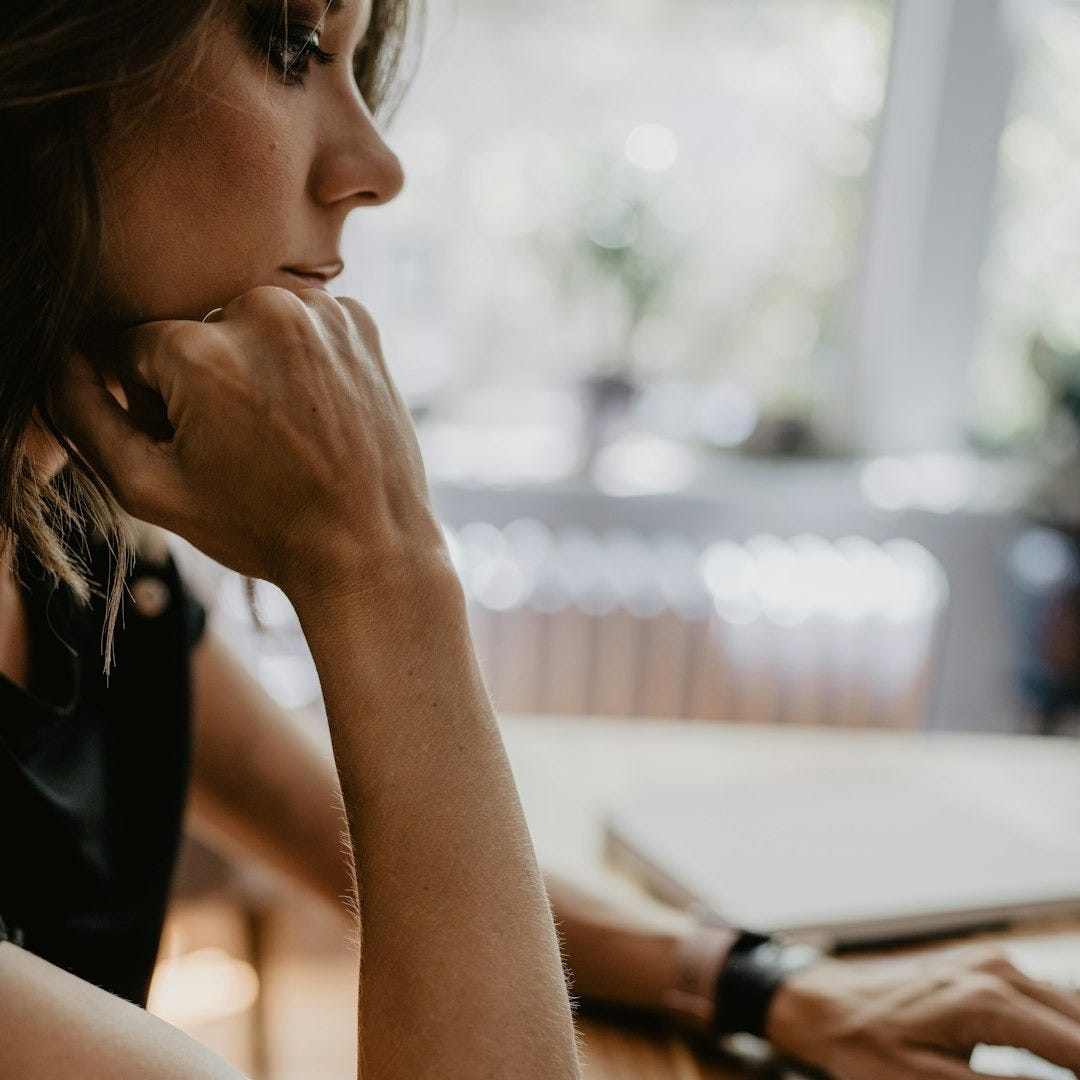 a woman sitting at a table a woman sitting at a table