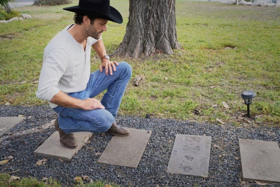 Walker Jared Padalecki looking at family handprints in stones leading to house Walker Jared Padalecki looking at family handprints in stones leading to house