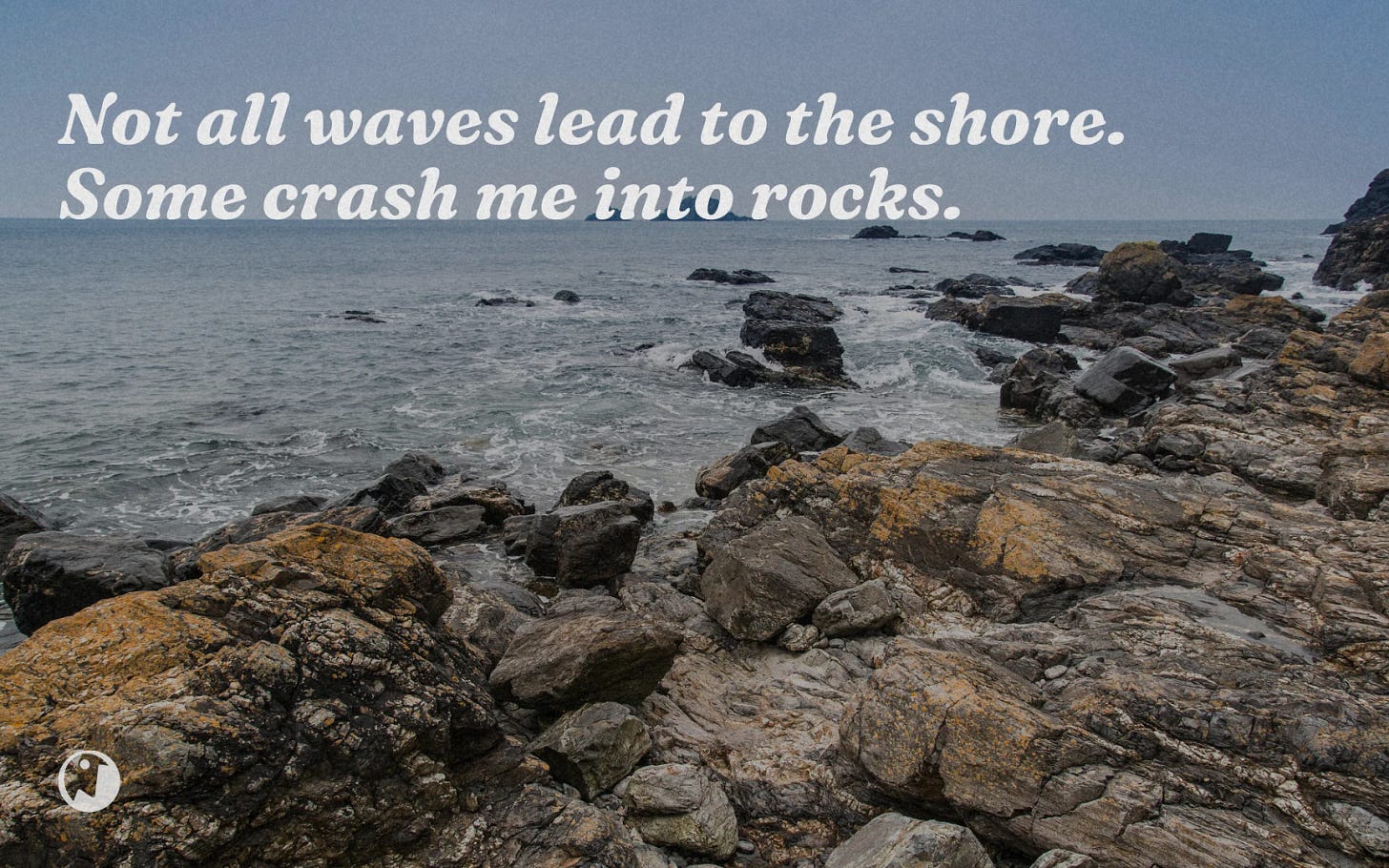 A serene yet rugged coastal landscape with waves breaking against rocky shores under a blue-gray sky.
