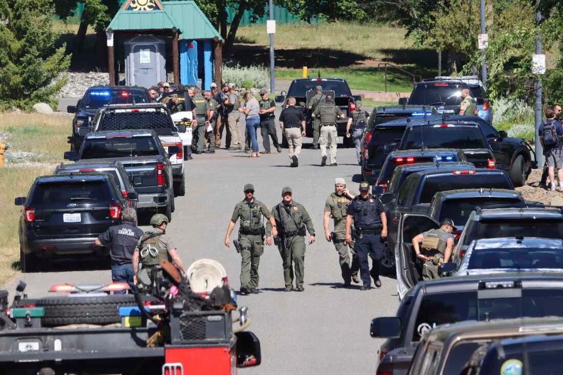 Law enforcement and emergency responders are shown on Sunday afternoon following reports of an ambush shooting attack on Canfield Mountain, in Coeur d'Alene, Idaho.