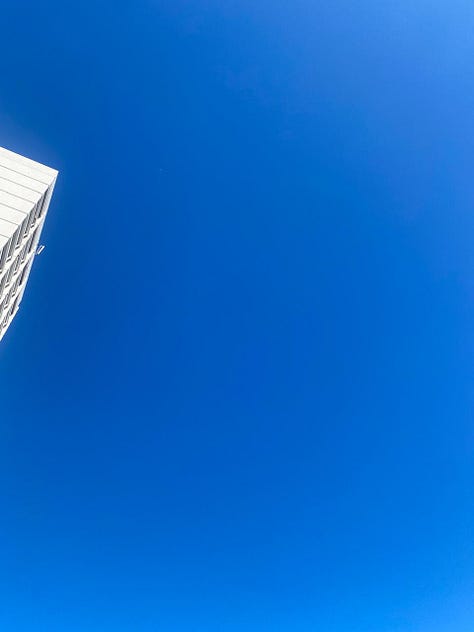 A white skyscraper against a cloudless blue