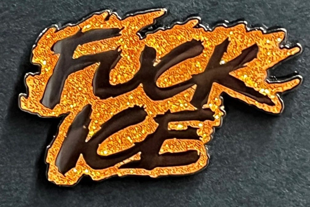 Enamel pin saying "Fuck ICE" in the font/style of Marvel's Ghost Rider comics logo.