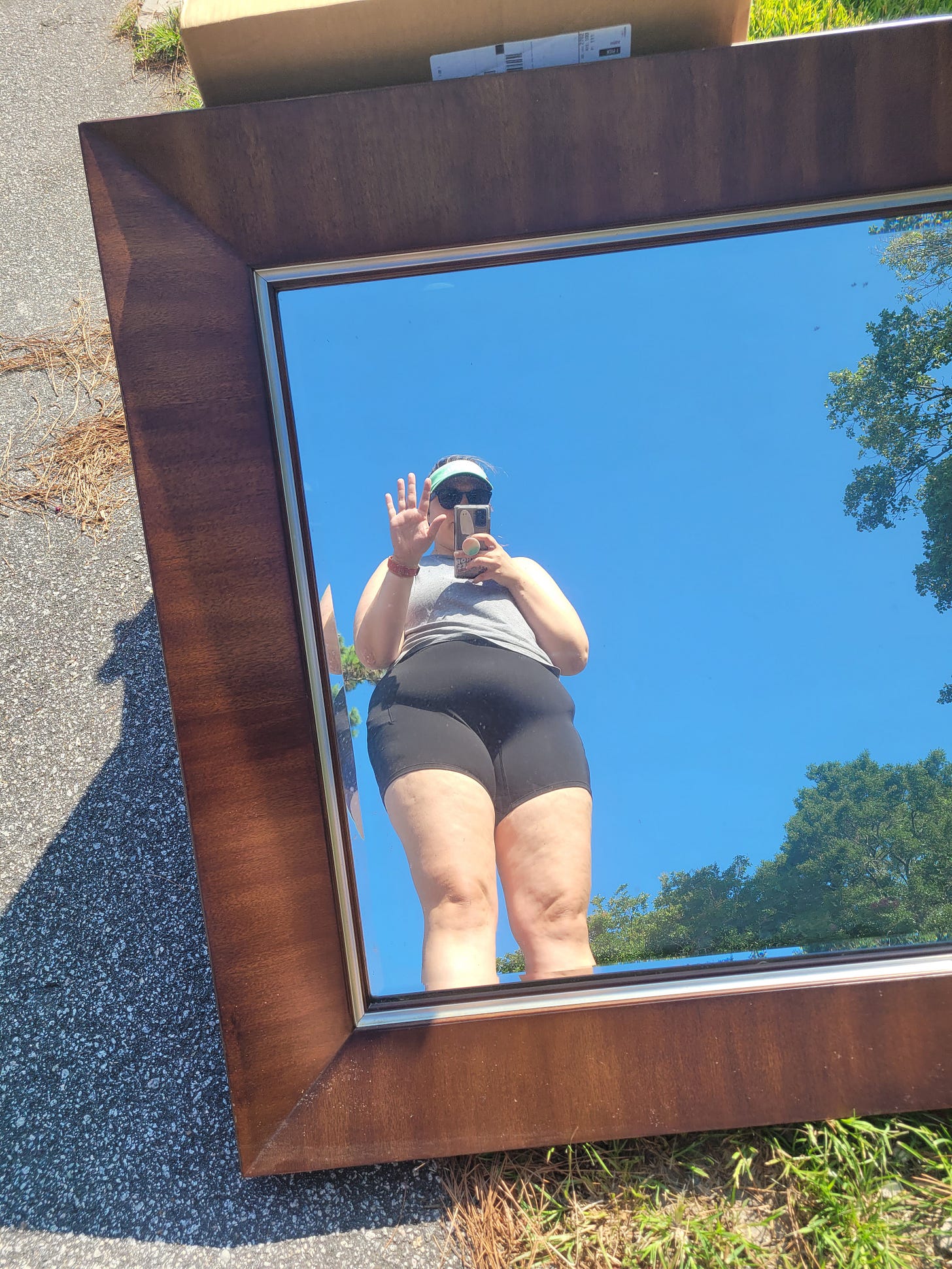 Sydney takes a selfie in mirror left on the side of the road during one of her runs.