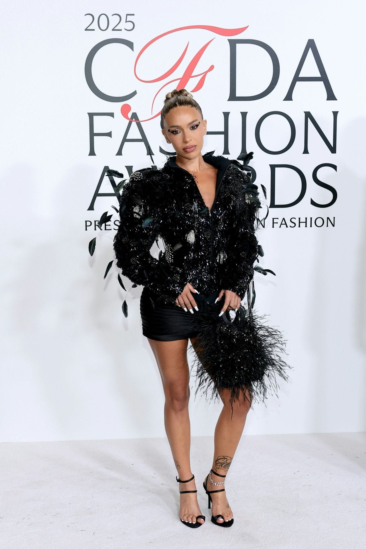 Bad Gyal in Feathered Black Ensemble at CFDA Fashion Awards 2025 •  CelebMafia