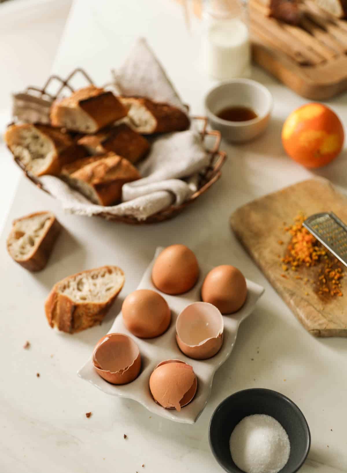 Ingredients laid out on a counter for making pain perdu. 