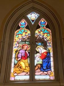 A stained glass window in a church

Description automatically generated