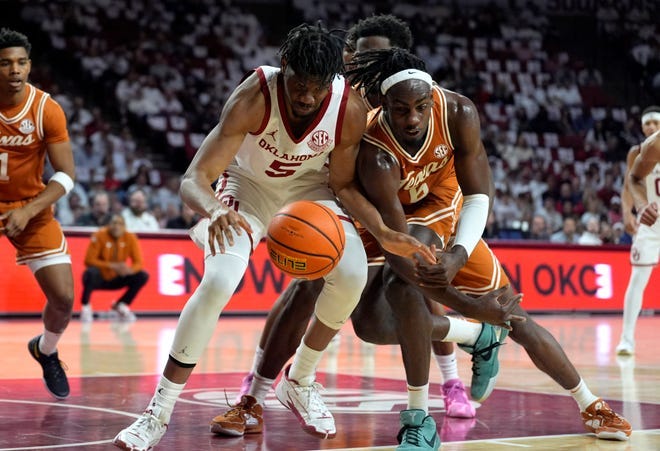 Oklahoma forward Mohamed Wague, left, and Texas forward Arthur Kaluma battle for a loose ball in the first half of an SEC showdown at Lloyd Noble Center in Norman, Okla., Wednesday.
