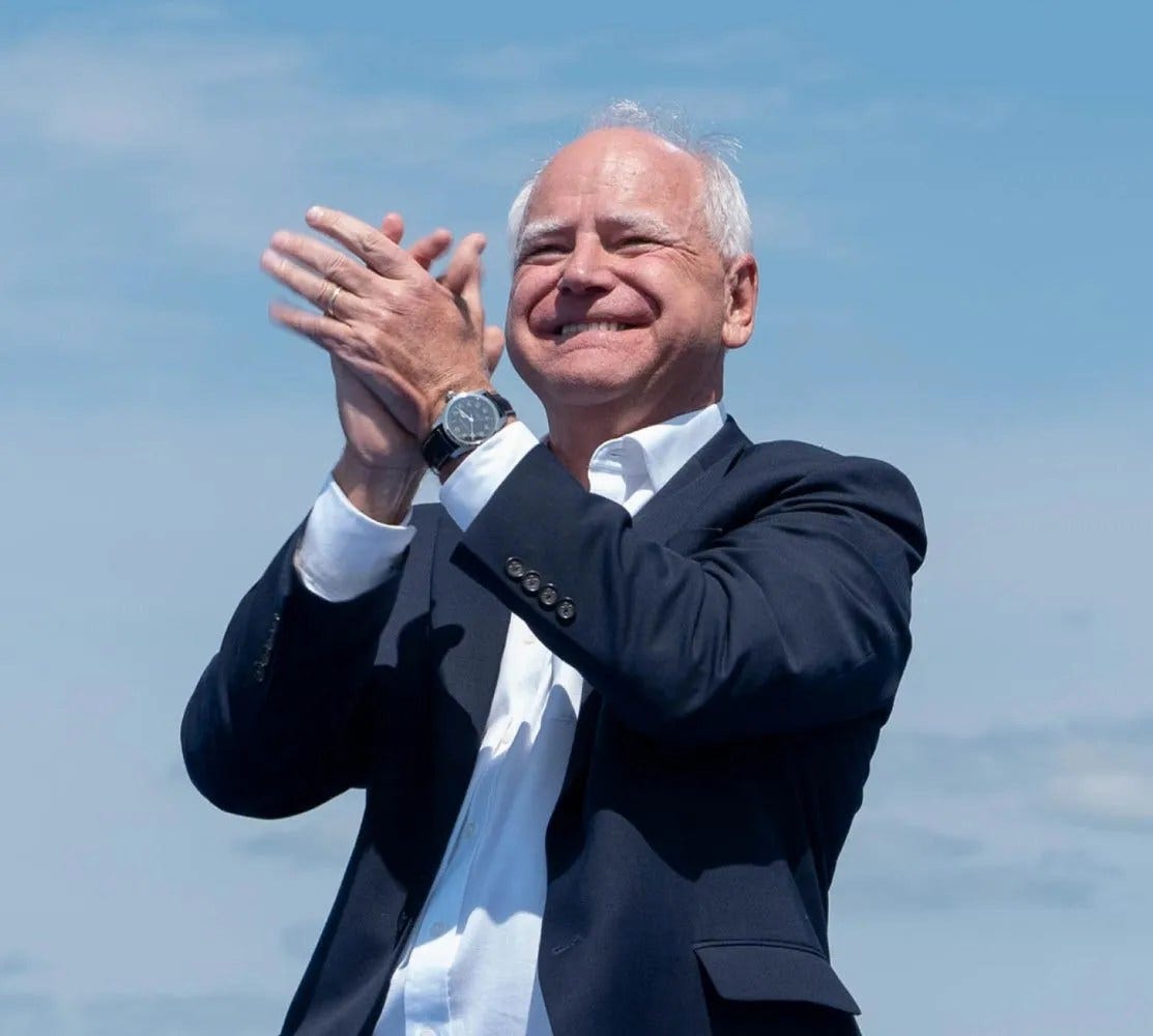 Governor Walz clapping with the sky behind him Governor Walz clapping with the sky behind him