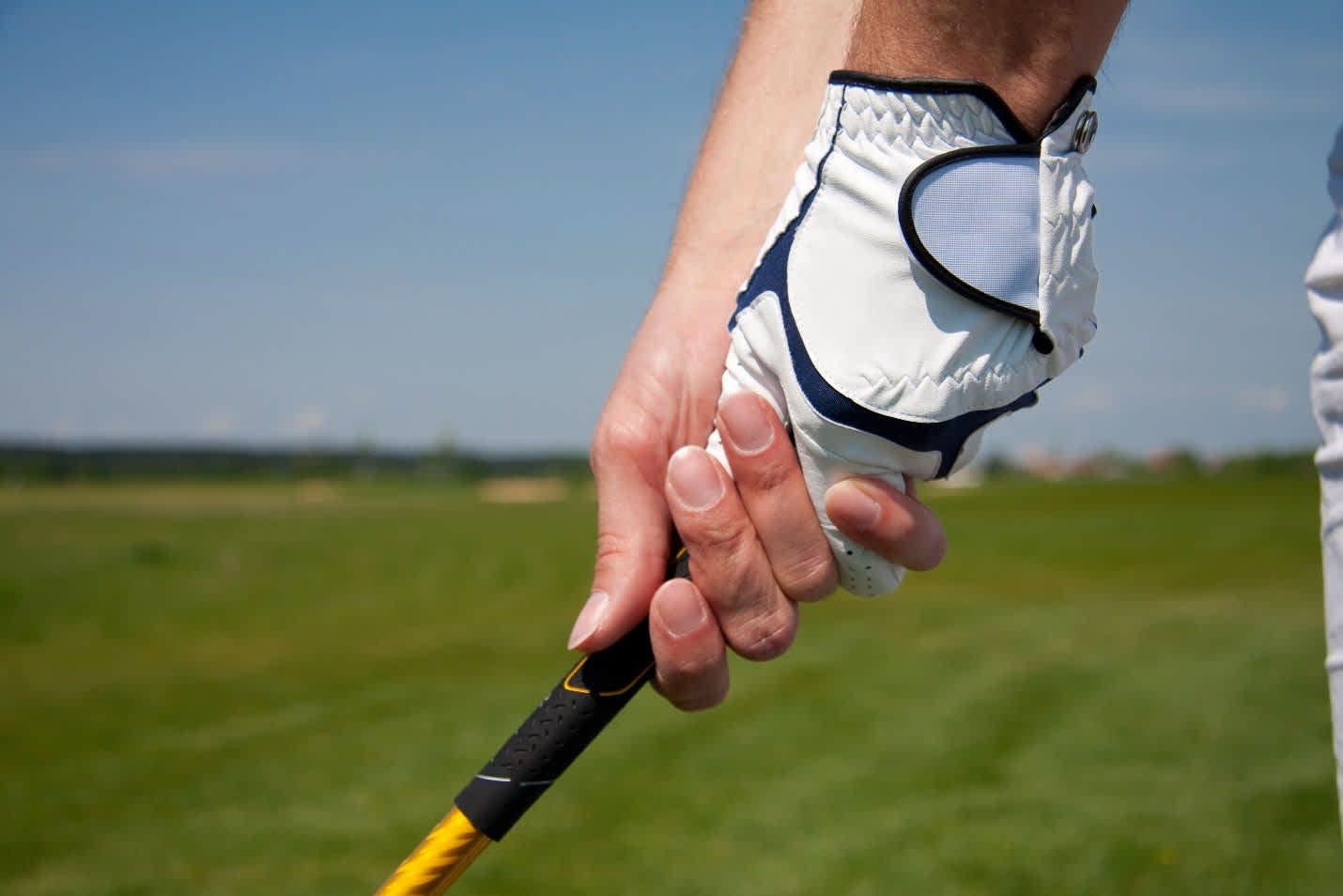 Proper golf grip technique demonstration emphasizing pinky pressure method for correct wrist hinge positioning Proper golf grip technique demonstration emphasizing pinky pressure method for correct wrist hinge positioning
