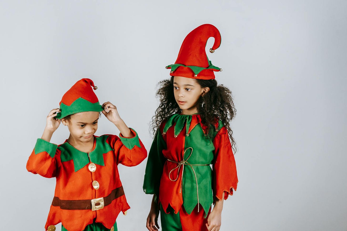 A young boy and girl dressed as Christmas Elves.