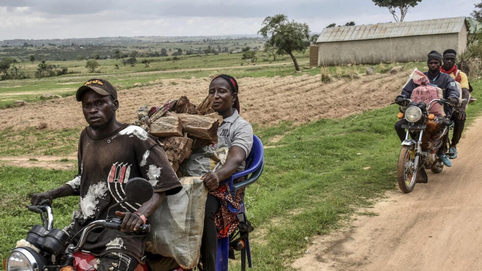 Residents transport their belongings as they flee on motorcycles towards Mangu, near Jos in the Plateau State in Nigeria, on May 20, 2023 escaping unrest in central Nigeria.