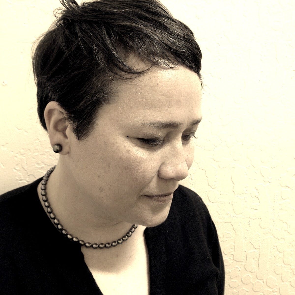 A picture of me in my early 40s wearing black pearl earrings, black pearl necklace, and a black cardigan. Typical librarian garb. A picture of me in my early 40s wearing black pearl earrings, black pearl necklace, and a black cardigan. Typical librarian garb.