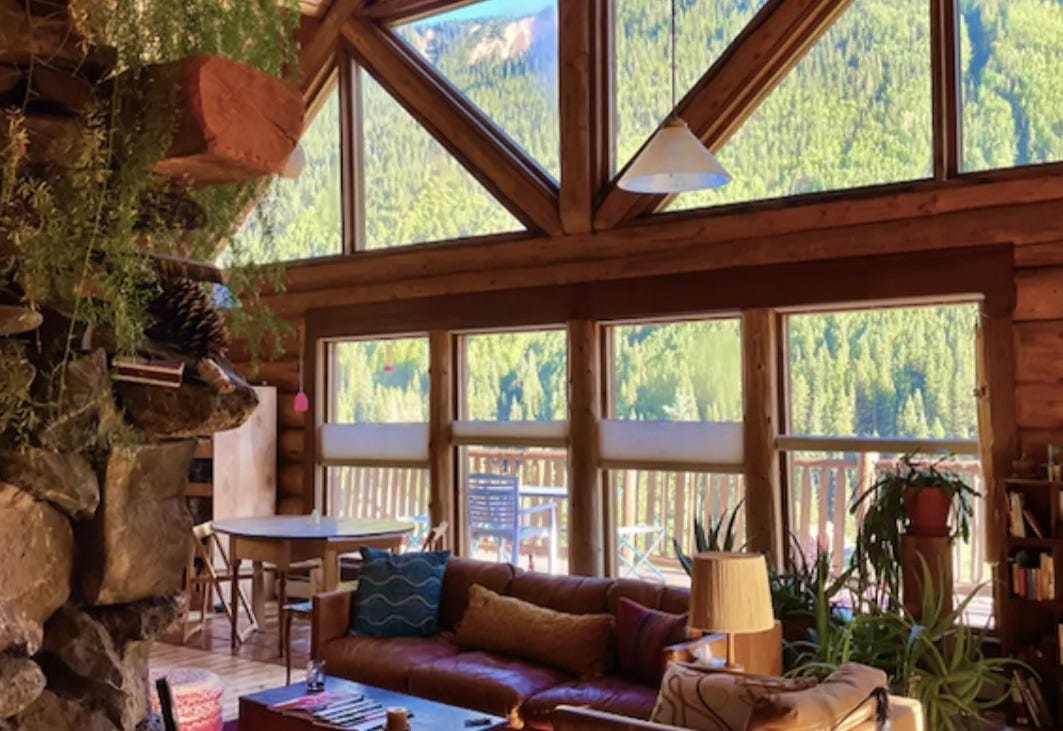 The view from Kelton’s window in her log cabin showing the gorgeous tree-covered Rockies in the distance. 