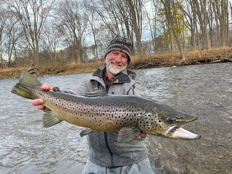 angler with large permit standing in the water