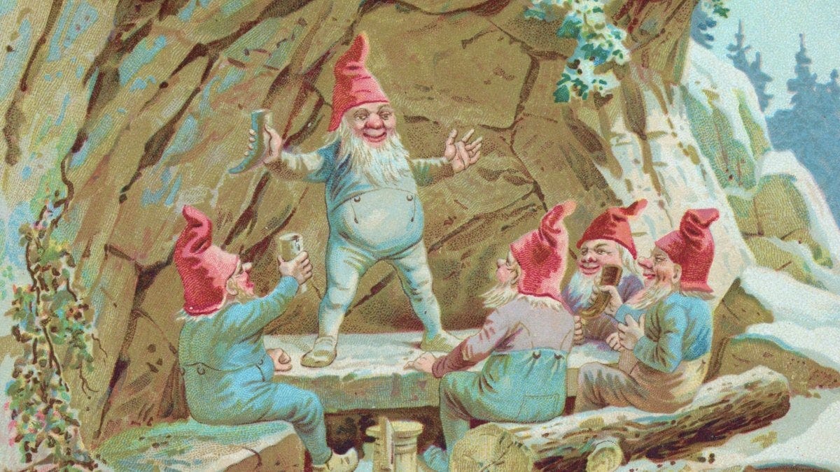 Five sociable gnomes with red hats sit and stand around a wooden bench in a snowy outdoor setting, appearing to share drinks and conversation near a rocky cave.