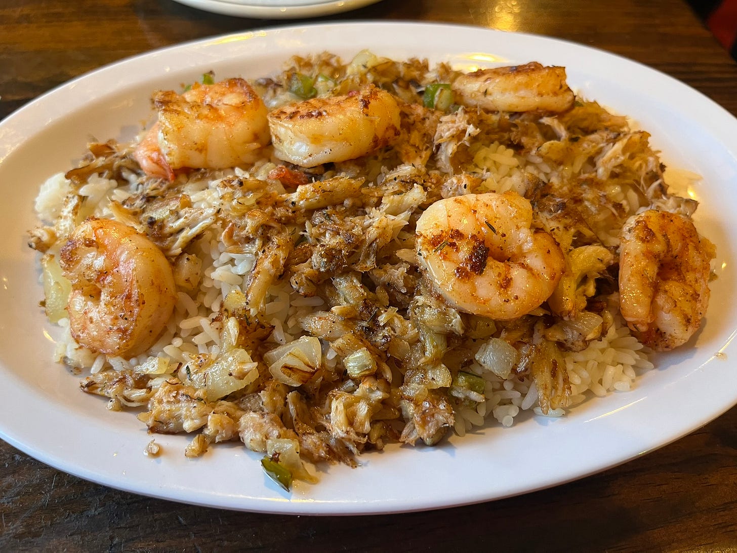 Cooked shrimp and browned crab meat, on top of white rice
