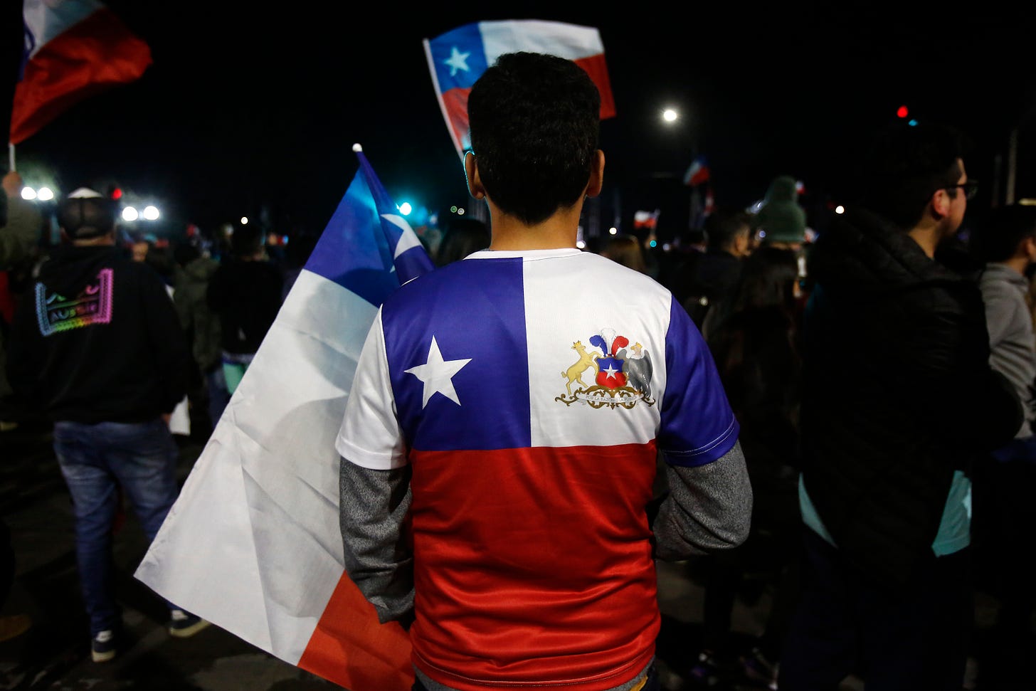 A demonstrator against the proposed constitution wears a jersey featuring the colors of the Chilean flag on September 4, 2022. (Photo by Jonnathan Oyarzun/Getty Images). A demonstrator against the proposed constitution wears a jersey featuring the colors of the Chilean flag on September 4, 2022. (Photo by Jonnathan Oyarzun/Getty Images).